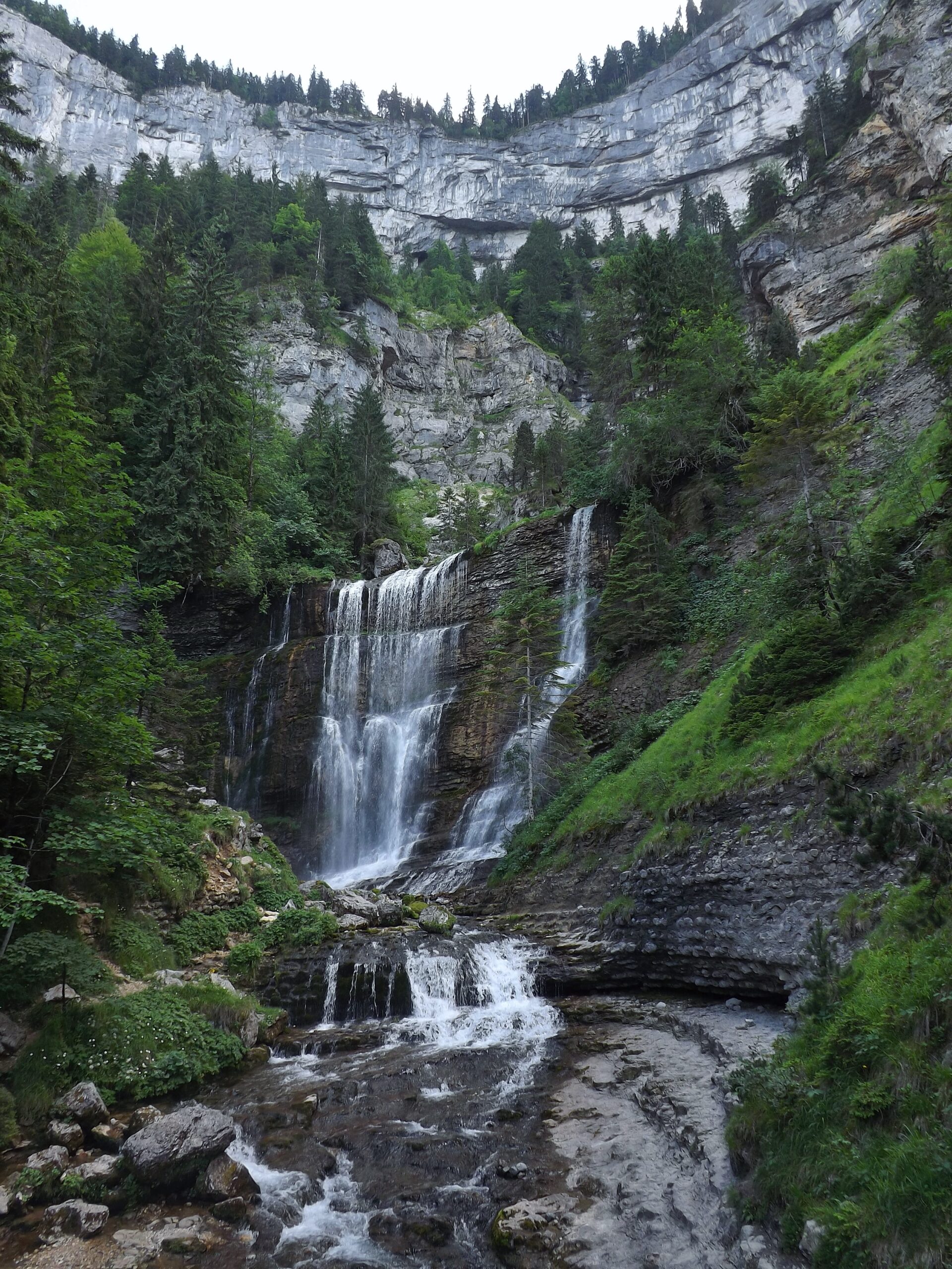 "Grande Cascade waterfall falling from limestone cliffs at Cirque de Saint-Même"